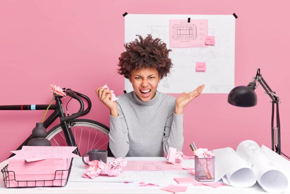 angry-female-architect-poses-at-table-with-papers-XRBZKJV.jpg